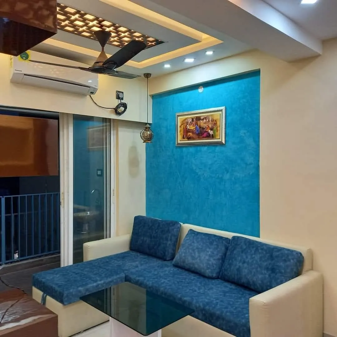 A modern [home renovation featuring] elegant interiors, [smart space planning], customised furniture [and refined finishes] by Agnimitra Interior [Design in Kolkata. Photo] Caption: